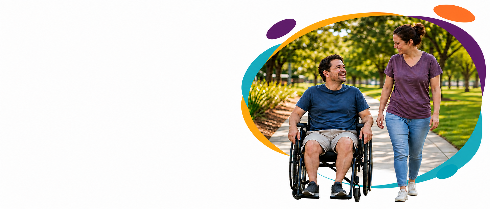 Qcare disability support worker alongside a wheelchair user in a park
